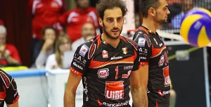 Two volleyball players moving to their positions on the court, ready to engage in the game.