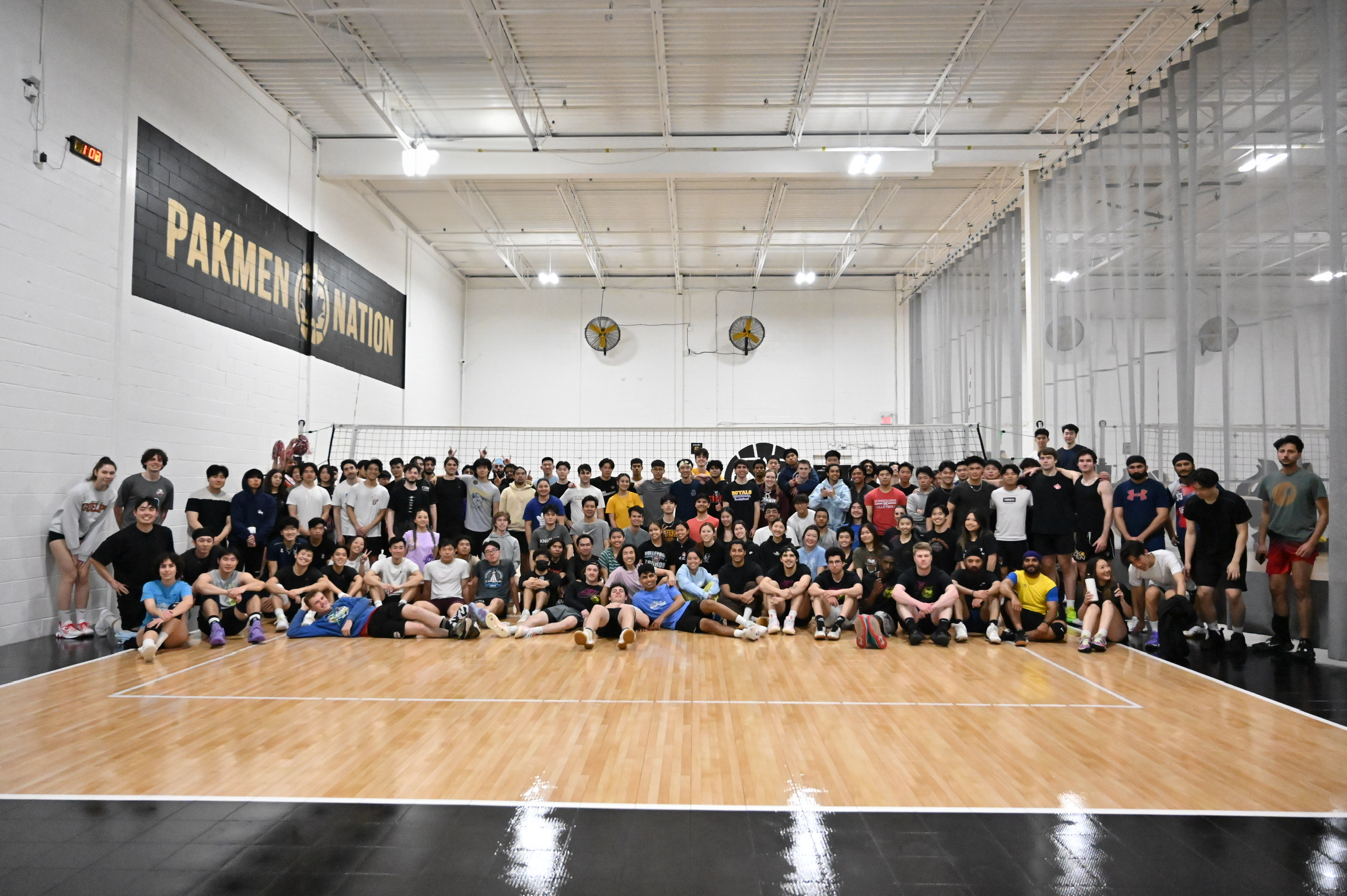 Volleyball players pictured together on an indoor court.
